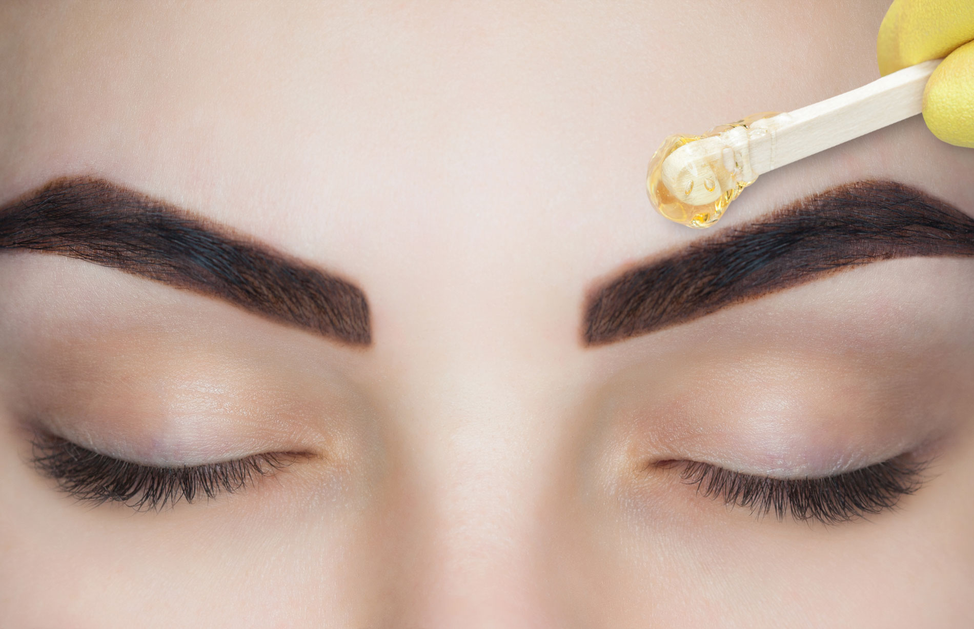 wax being applied around eyebrows