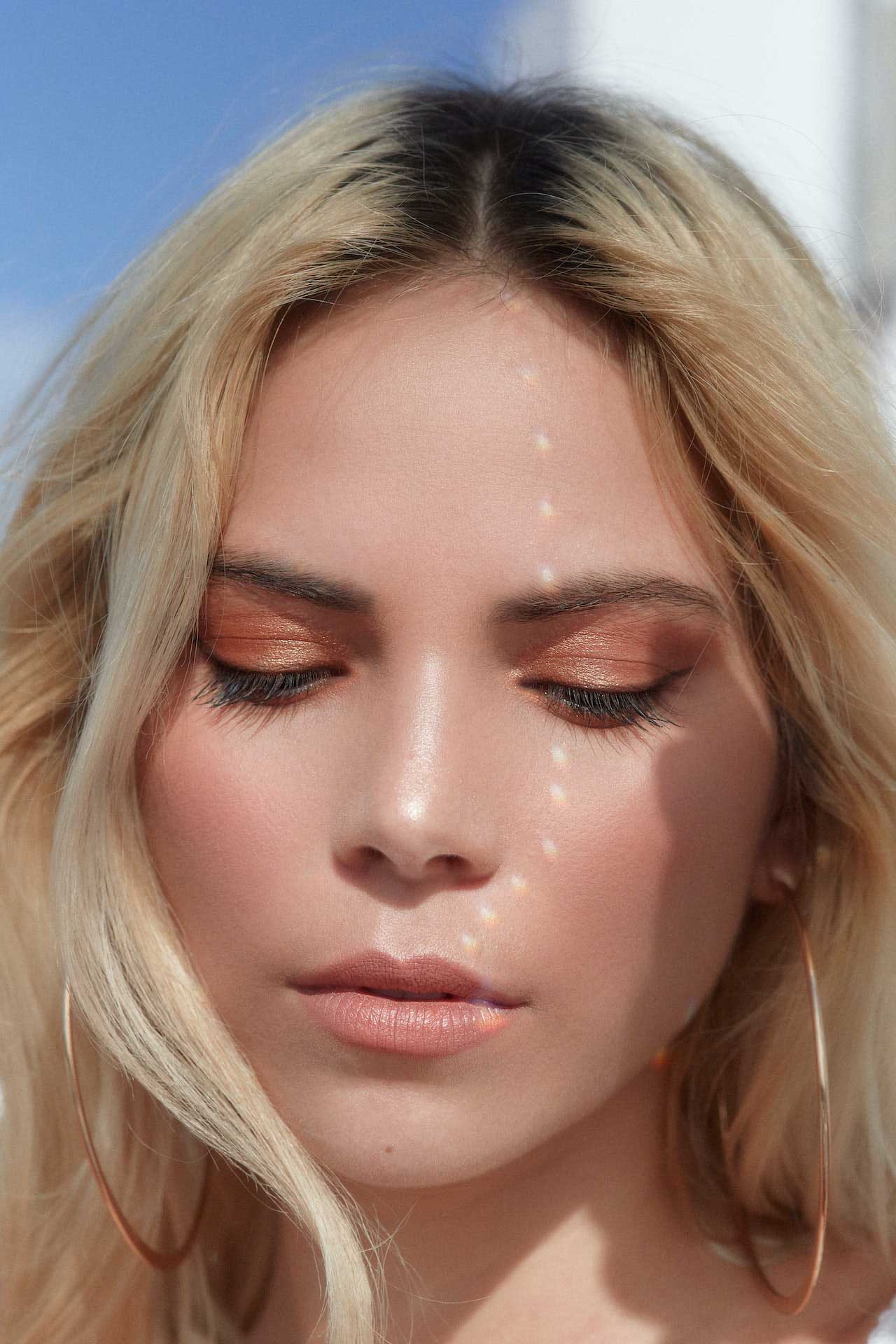 Girl looking down with makeup on