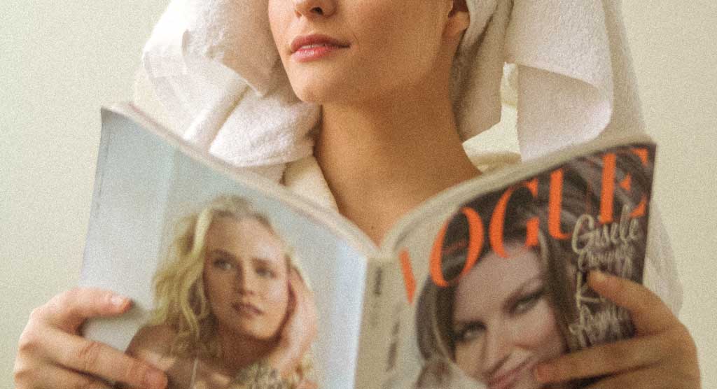 Woman holding vogue magazine