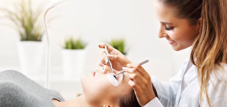 woman adjusting customers eyebrows