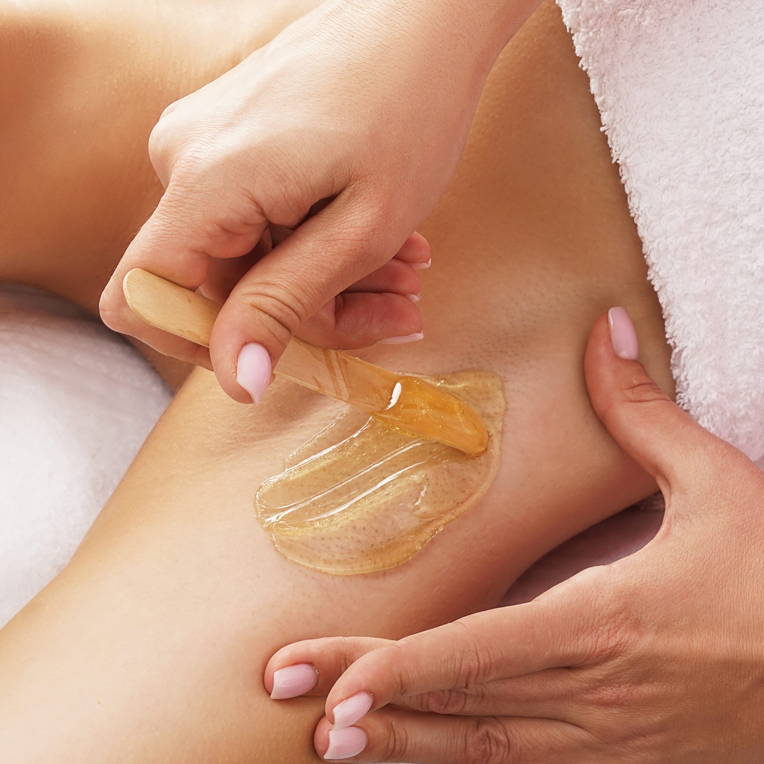 beautician,is,removing,hair,from,young,female,armpits,with,hot