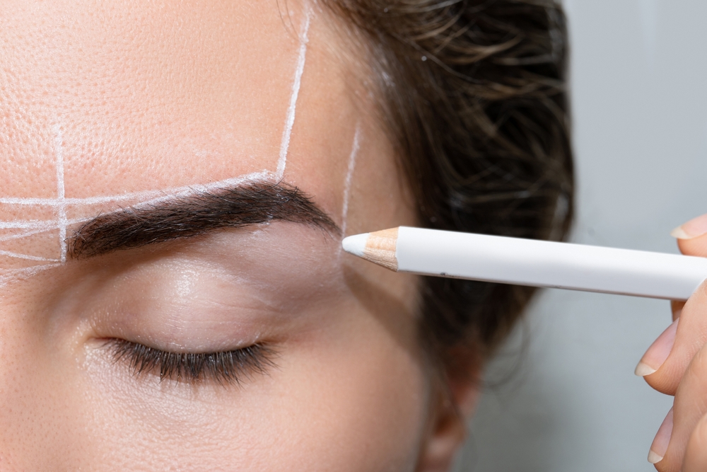 young,woman,during,professional,eyebrow,mapping,procedure,before,permanent,makeup