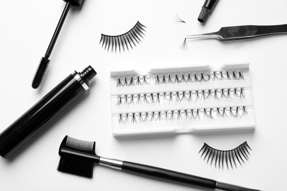 composition,with,false,eyelashes,and,tools,on,white,background,,top