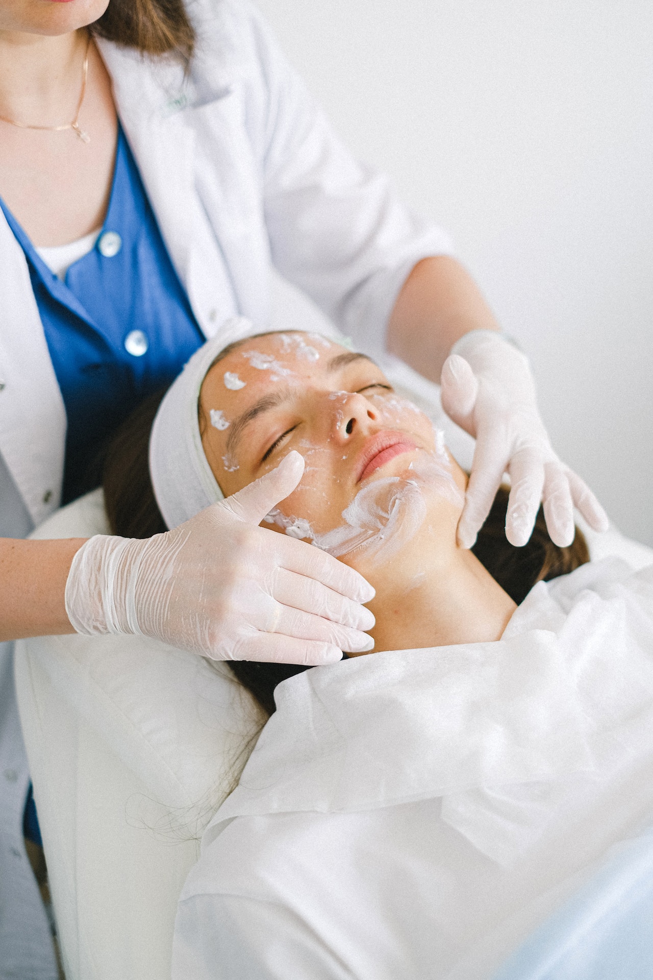 Beauty therapist performing a facial on a woman