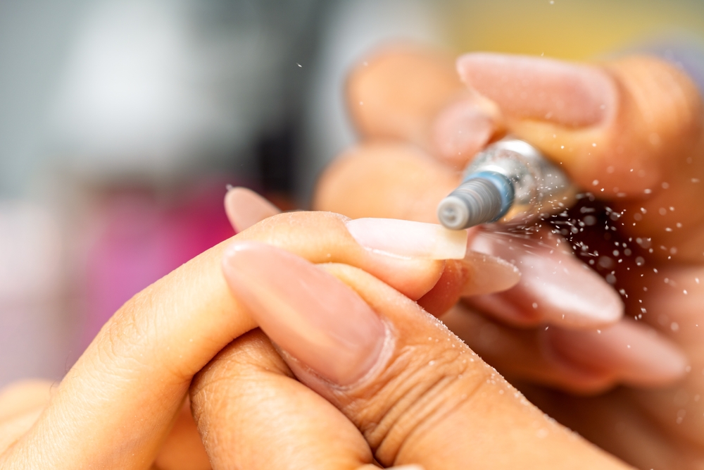 nail,technician,performing,a,professional,manicure,service,,shaping,artificial,nails