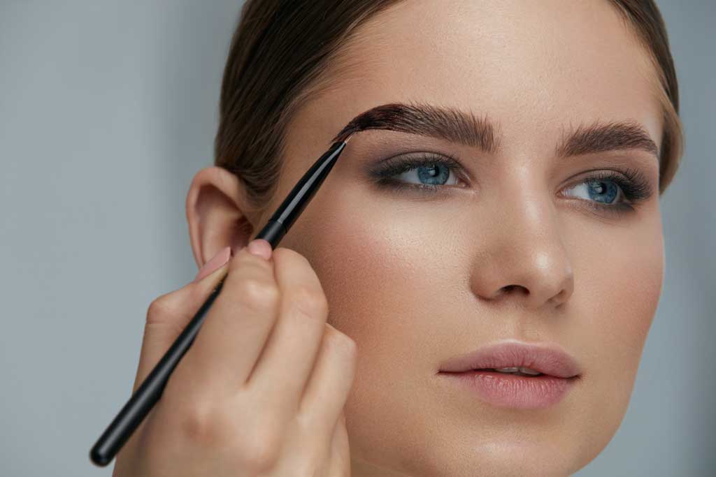 A woman having eyebrow tint applied