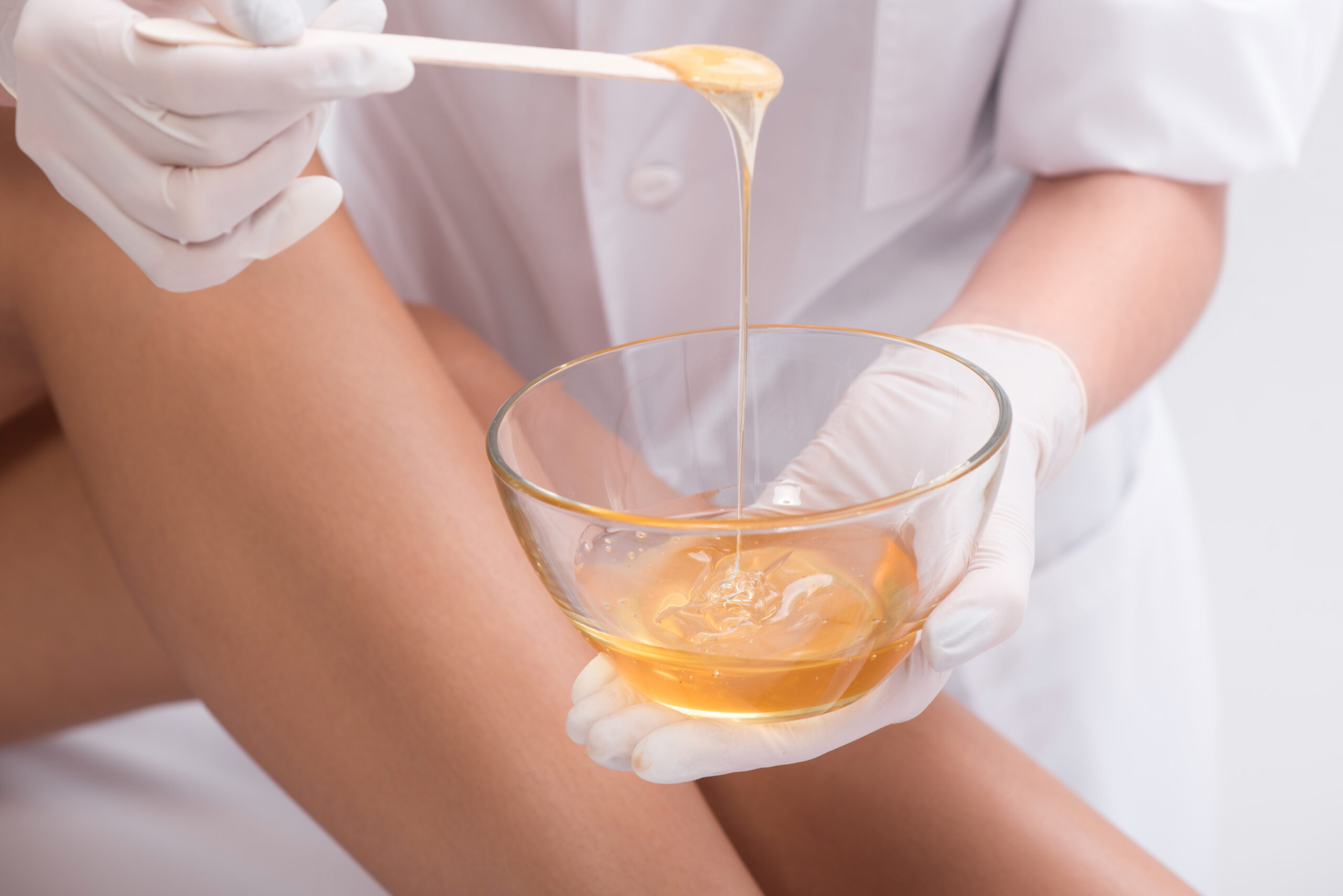 young,woman,waxing,her,lower,leg